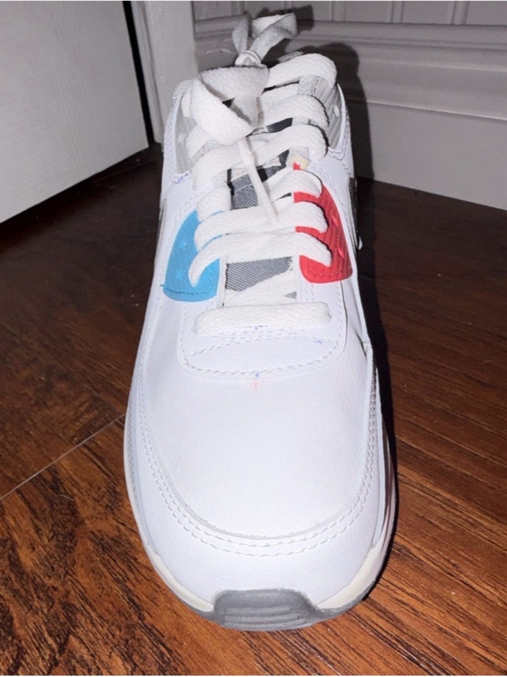 Nike Kids White Sneaker with Blue and Red Accents